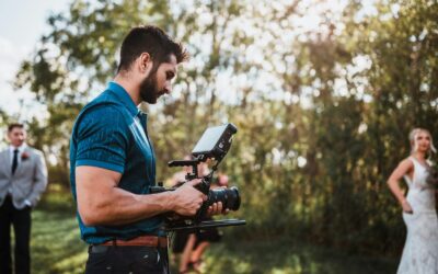A man standing next to a woman holding a camera