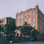 A red brick building sitting on the side of a road