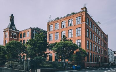 A red brick building sitting on the side of a road