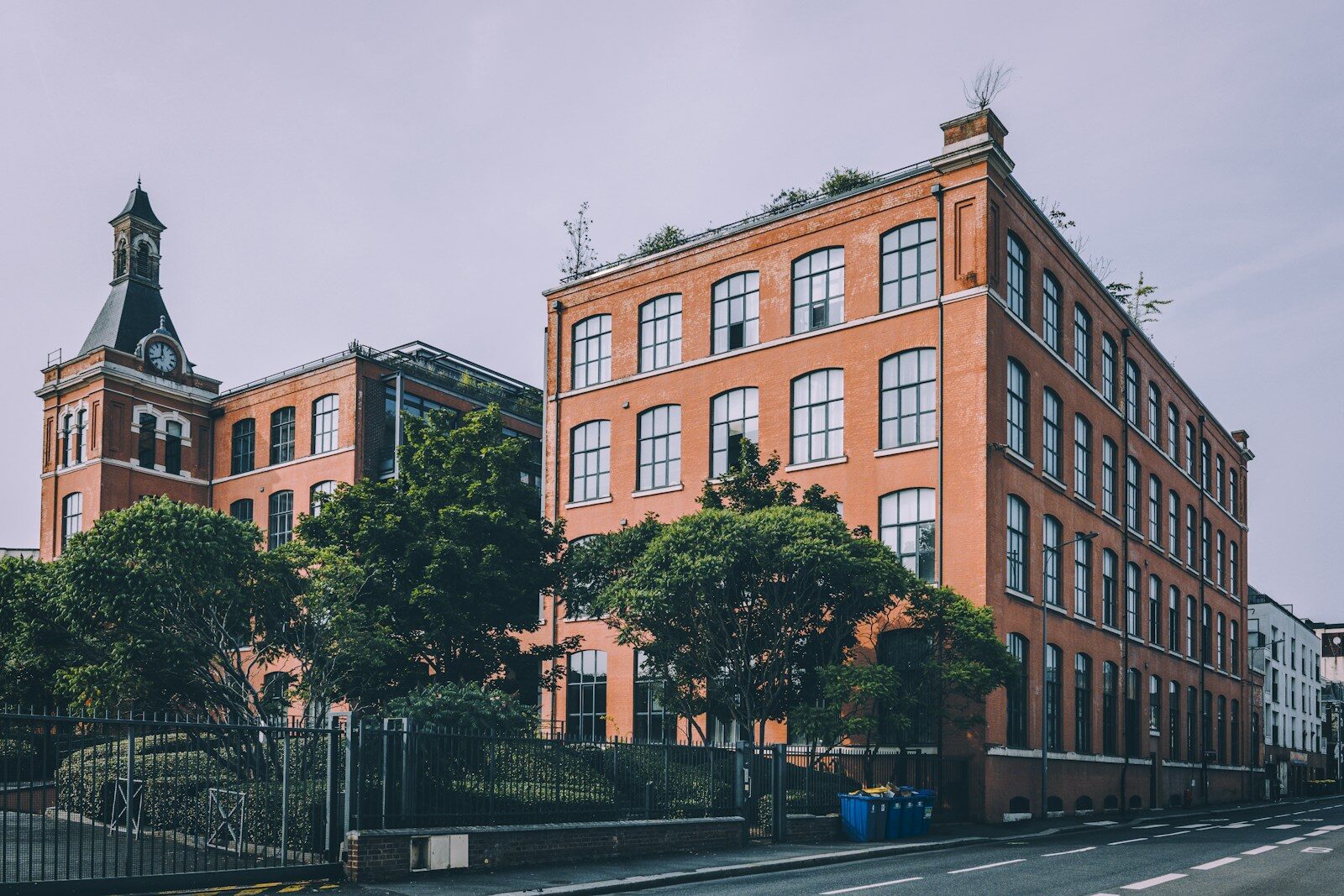 A red brick building sitting on the side of a road