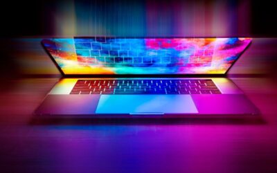 Un ordinateur portable ouvert sur une table, écran lumineux aux couleurs vives